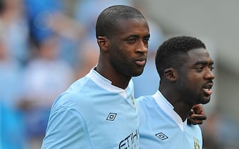 Manchester City's Ivorian midfielder Yaya Toure (L) celebrates with his brother Kolo Toure (R) on the pitch after their 3-2 victory over Queens Park Rangers in the English Premier League football match between Manchester City and Queens Park Rangers at The Etihad stadium in Manchester, north-west England on May 13, 2012. Manchester City won the game 3-2 to secure their first title since 1968. This is the first time that the Premier league title has been decided on goal-difference, Manchester City and Manchester United both finishing on 89 points. AFP PHOTO/PAUL ELLIS

RESTRICTED TO EDITORIAL USE. No use with unauthorized audio, video, data, fixture lists, club/league logos or 'live' services. Online in-match use limited to 45 images, no video emulation. No use in betting, games or single club/league/player publications.        (Photo credit should read PAUL ELLIS/AFP via Getty Images)