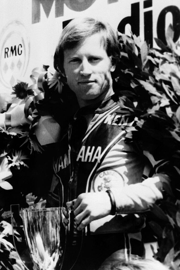 A file picture taken on April 16, 1977 shows US motorcycle racer Kenny Roberts, posing with the trophy on the podium after wining the 250cc category race in Le Castellet. / AFP / -        (Photo credit should read -/AFP via Getty Images)