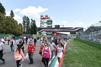 People walk to reach the curve of the "Tamburello" track to take part in a ceremony marking the 25th anniversary of the death of Brazilian's F1 driver Ayrton Senna at the Imola "Enzo and Dino Ferrari" circuit during the 1994 San Marino Grand Prix. (Photo by ANDREAS SOLARO / AFP)        (Photo credit should read ANDREAS SOLARO/AFP via Getty Images)