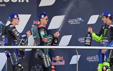 (L-R) Monster Energy Yamaha's second-placed Spanish rider Maverick Vinales, Petronas Yamaha SRT's French winner Fabio Quartararo and Monster Energy Yamaha's third-placed Italian rider Valentino Rossi celebrate on the podium after the MotoGP race during the Andalucia Grand Prix at the Jerez race track in Jerez de la Frontera on July 26, 2020. (Photo by JAVIER SORIANO / AFP) (Photo by JAVIER SORIANO/AFP via Getty Images)