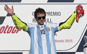 Italy's biker Valentino Rossi of Yamaha celebrates on the podium after winning the Argentina Grand Prix at Termas de Rio Hondo circuit, in Santiago del Estero, on April 19, 2015. Valentino Rossi survived a late battle with defending world champion Marc Marquez, who crashed with two laps to go.  AFP PHOTO / JUAN MABROMATA        (Photo credit should read JUAN MABROMATA/AFP via Getty Images)