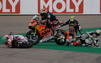 (L-R) Red Bull KTM Ajo's Japanese rider Tetsuta Nagashima, Liqui Moly Intact GP's Swiss rider Thomas Luethi and Onexox TKKR SAG's Malaysian rider Kasma Daniel crash while competing in the Moto2 race at the Grand Prix of Teruel at the Motorland circuit in Alcaniz on October 25, 2020. (Photo by PIERRE-PHILIPPE MARCOU / AFP) (Photo by PIERRE-PHILIPPE MARCOU/AFP via Getty Images)