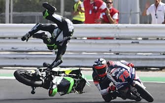 TOPSHOT - CIP Green Power's South African rider Darryn Binder flies off his bike after he crashed during the Moto3 race of the Emilia Romagna Grand Prix at the Misano World Circuit Marco Simoncelli on September 20, 2020. (Photo by ANDREAS SOLARO / AFP) (Photo by ANDREAS SOLARO/AFP via Getty Images)