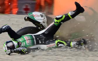 TOPSHOT - LCR Honda's British rider Cal Crutchlow crashes during the third MotoGP free practice session of the Moto Grand Prix de Catalunya at the Circuit de Catalunya on September 26, 2020 in Montmelo on the outskirts of Barcelona. (Photo by LLUIS GENE / AFP) (Photo by LLUIS GENE/AFP via Getty Images)