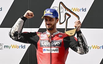 epa08607110 First placed Italian MotoGP rider Andrea Dovizioso of Ducati Team celebrates on the podium after the Motorcycling Grand Prix of Austria at the Red Bull Ring in Spielberg, Austria, 16 August 2020.  EPA/CHRISTIAN BRUNA