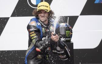 epa08619592 First placed Italian Moto2 rider Marco Bezzecchi of Sky Racing Team VR46 celebrates on the podium after the Motorcycling Grand Prix of Styria at the Red Bull Ring in Spielberg, Austria, 23 August 2020.  EPA/CHRISTIAN BRUNA