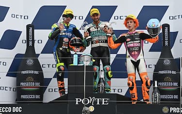 (From L) Runner-up Avintia VR46 team rider Italy's Niccolo Antonelli, race winner Leopard Racing Team Italian rider Dennis Foggia and third-placed Rivacold Snipers Team Italian rider Andrea Migno celebrate on the podium after the San Marino Moto3 Grand Prix at the Misano World Circuit Marco-Simoncelli on September 19, 2021 in Misano Adriatico, Italy. (Photo by ANDREAS SOLARO / AFP) (Photo by ANDREAS SOLARO/AFP via Getty Images)