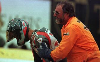Pierfrancesco Chili is helped by a marshall after his clash with Carl Fogarty  (Photo by John Marsh/EMPICS via Getty Images)