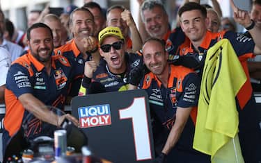 Red Bull KTM AJO's Spanish rider Augusto Fernandez (C) celebrates with his team after victory in the Moto2 race of the British Grand Prix at Silverstone circuit in Northamptonshire, central England, on August 7, 2022. (Photo by ADRIAN DENNIS / AFP) (Photo by ADRIAN DENNIS/AFP via Getty Images)