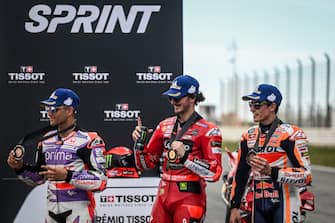 First-placed Ducati Italian rider Francesco Bagnaia (C), second-placed Ducati Spanish rider Jorge Martin (L) and third-placed Honda Spanish rider Marc Marquez pose for pictures on the podium after the sprint race of the MotoGP Portuguese Grand Prix at the Algarve International Circuit in Portimao, on March 25, 2023. (Photo by PATRICIA DE MELO MOREIRA / AFP) (Photo by PATRICIA DE MELO MOREIRA/AFP via Getty Images)