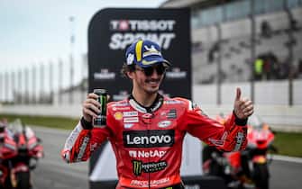 First-placed Ducati Italian rider Francesco Bagnaia poses for pictures after the sprint race of the MotoGP Portuguese Grand Prix at the Algarve International Circuit in Portimao, on March 25, 2023. (Photo by PATRICIA DE MELO MOREIRA / AFP) (Photo by PATRICIA DE MELO MOREIRA/AFP via Getty Images)