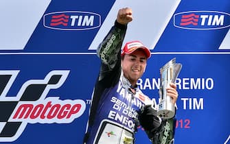 Spain's 2010 world champion Jorge Lorenzo celebrates on the podium after winning the Italian MotoGP a the Mugello Circuit near Scarperia on July 15, 2012. The 25-year-old Yamaha rider - who ended a two race winless run having last won the British MotoGP on June 17 - came home clear of compatriot Dani Pedrosa on a Honda while Italian Andrea Dovizioso was third on another Yamaha. AFP PHOTO / GIUSEPPE CACACE        (Photo credit should read GIUSEPPE CACACE/AFP/GettyImages)
