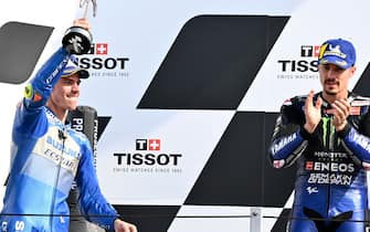Suzuki Ecstar's Spanish rider Joan Mir (L) celebrates after finishing second as winner Monster Energy Yamaha' Spanish rider Maverick Vinales watches on the podium after the Emilia Romagna MotoGP Grand Prix at the Misano World Circuit Marco Simoncelli on September 20, 2020. (Photo by ANDREAS SOLARO / AFP) (Photo by ANDREAS SOLARO/AFP via Getty Images)