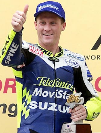 Kenny Roberts Jr of the US gives a thumbs up after winning the 500cc race at the Malaysian Motorcycle Grand Prix at the Sepang F1 Circuit 02 April 2000. Roberts won the race ahead of Carlos Checa of Spain in second and Garry McCoy of Australia in third after the race was stopped after 17 laps as it started to rain. (ELECTRONIC IMAGE)  AFP PHOTO/Jimin LAI (Photo by JIMIN LAI / AFP)        (Photo credit should read JIMIN LAI/AFP via Getty Images)