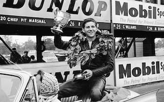 Motor Cycle Racing at Oulton Park. Phil Read celebrates with the trophy on a lap of honour after winning the British Junior Championship race. 7th July 1963. (Photo by Daily Mirror/Mirrorpix/Mirrorpix via Getty Images)
