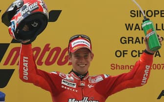 Shanghai, CHINA: Australian MotoGP rider Casey Stoner from the Ducati Team celebrates after winning the MotoGP race at the Grand Prix of China on the Shanghai International Circuit 06 May 2007.  Motorcycling star Casey Stoner powered his MotoGP Ducati to victory in the Grand Prix of China here in a tightly fought contest against seven-time world champion Valentino Rossi. The Australian completed the Shanghai race in 44mins 12.891secs, with Italy's Rossi on a Yamaha 3.036 seconds off the pace and John Hopkins of the US on a Suzuki finishing third for his first-ever podium.   AFP PHOTO/Mark RALSTON (Photo credit should read MARK RALSTON/AFP via Getty Images)