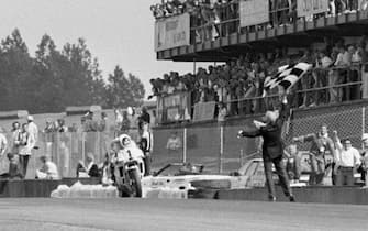 Eddie Lawson takes the chequered flag to win the British Moto GP  (Photo by EMPICS Sport - PA Images via Getty Images)