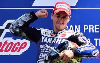 Spain's 2010 world champion Jorge Lorenzo celebrates on the podium after winning the Italian MotoGP a the Mugello Circuit near Scarperia on July 15, 2012. The 25-year-old Yamaha rider - who ended a two race winless run having last won the British MotoGP on June 17 - came home clear of compatriot Dani Pedrosa on a Honda while Italian Andrea Dovizioso was third on another Yamaha.  AFP PHOTO / GIUSEPPE CACACE        (Photo credit should read GIUSEPPE CACACE/AFP/GettyImages)
