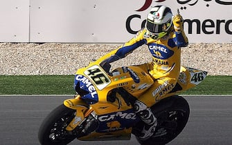 Doha, QATAR:  Italian rider and world champion Valentino Rossi of Yamaha jubilates after winning the Qatar Grand Prix World Championship 08 April 2006, at the Losail International Circuit in Qatar. Rossi equalled the record of 54 Grand Prix wins held by Australian great Mick Doohan with success in the Qatar MotoGP. The Italian Yamaha ace's second successive victory was gained at the expense of Nicky Hayden of the United States with Rossi's compatriot Loris Capirossi, winner of the season-opener in Spain last month, taking third.   AFP PHOTO/KARIM JAAFAR  (Photo credit should read KARIM JAAFAR/AFP via Getty Images)