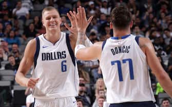 DALLAS, TX - OCTOBER 14: Kristaps Porzingis #6 high fives teammate Luka Doncic #77 of the Dallas Mavericks during a pre-season game against the Oklahoma City Thunder on October 14, 2019 at the American Airlines Center in Dallas, Texas. NOTE TO USER: User expressly acknowledges and agrees that, by downloading and or using this photograph, User is consenting to the terms and conditions of the Getty Images License Agreement. Mandatory Copyright Notice: Copyright 2019 NBAE (Photo by Glenn James/NBAE via Getty Images)