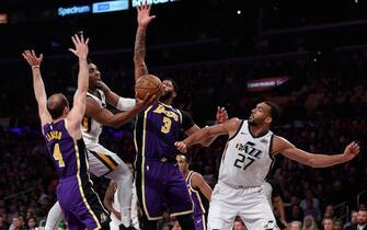 LOS ANGELES, CALIFORNIA - OCTOBER 25:  Donovan Mitchell #45 of the Utah Jazz drives to the basket between Anthony Davis #3 and Alex Caruso #4 of the Los Angeles Lakers with Rudy Gobert #27 during a 95-86 Lakers win at Staples Center on October 25, 2019 in Los Angeles, California. (Photo by Harry How/Getty Images)