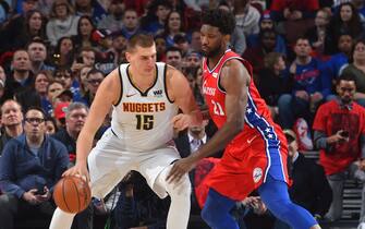 PHILADELPHIA, PA - FEBRUARY 8: Joel Embiid #21 of the Philadelphia 76ers plays defense against the Nikola Jokic #15 of the Denver Nuggets on February 8, 2019 at the Wells Fargo Center in Philadelphia, Pennsylvania. NOTE TO USER: User expressly acknowledges and agrees that, by downloading and/or using this photograph, user is consenting to the terms and conditions of the Getty Images License Agreement. Mandatory Copyright Notice: Copyright 2019 NBAE (Photo by Jesse D. Garrabrant/NBAE via Getty Images)