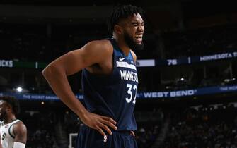 MILWAUKEE, WI - OCTOBER 17: Karl-Anthony Towns #32 of the Minnesota Timberwolves laughs during a pre-season game against the Milwaukee Bucks on October 17 , 2019 at the Fiserv Forum Center in Milwaukee, Wisconsin. NOTE TO USER: User expressly acknowledges and agrees that, by downloading and or using this Photograph, user is consenting to the terms and conditions of the Getty Images License Agreement. Mandatory Copyright Notice: Copyright 2019 NBAE (Photo by Gary Dineen/NBAE via Getty Images).