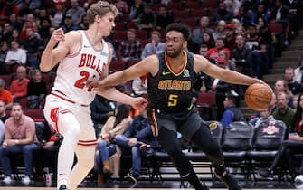 CHICAGO, ILLINOIS - OCTOBER 17:  Jabari Parker #5 of the Atlanta Hawks dribbles the ball while being guarded by Lauri Markkanen #24 of the Chicago Bulls in the first quarter during a preseason game at the United Center on October 17, 2019 in Chicago, Illinois. NOTE TO USER: User expressly acknowledges and agrees that, by downloading and/or using this photograph, user is consenting to the terms and conditions of the Getty Images License Agreement. (Photo by Dylan Buell/Getty Images)