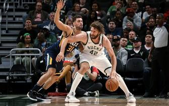 MILWAUKEE, WISCONSIN - OCTOBER 09:  Robin Lopez #42 of the Milwaukee Bucks dribbles the ball while being guarded by Georges Niang #31 of the Utah Jazz in the first quarter during a preseason game at Fiserv Forum on October 09, 2019 in Milwaukee, Wisconsin. NOTE TO USER: User expressly acknowledges and agrees that, by downloading and or using this photograph, User is consenting to the terms and conditions of the Getty Images License Agreement. (Photo by Dylan Buell/Getty Images)