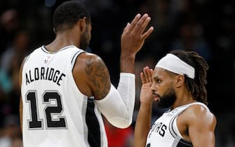 1176752230 SAN ANTONIO, TX - OCTOBER 18: LaMarcus Aldridge #12 of the San Antonio Spurs and teammate Patty Mills #8 celebrate after Mills scored a 3-pointer during a preseason NBA game against the Memphis Grizzlies held at the AT&T Center on October 18, 2019 in San Antonio, Texas. The Spurs won 104-91. NOTE TO USER: User expressly acknowledges and agrees that, by downloading and or using this photograph, User is consenting to the terms and conditions of the Getty Images License Agreement. (Photo by Edward A. Ornelas/Getty Images)