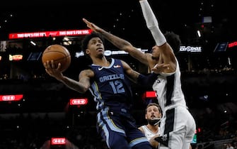 1176666448 SAN ANTONIO, TX - OCTOBER 18: Ja Morant #12 of the Memphis Grizzlies shoots around Dejounte Murray #5 of the San Antonio Spurs as Rudy Gay #22 moves in on the play during a preseason NBA game held at the AT&T Center on October 18, 2019 in San Antonio, Texas. NOTE TO USER: User expressly acknowledges and agrees that, by downloading and or using this photograph, User is consenting to the terms and conditions of the Getty Images License Agreement. (Photo by Edward A. Ornelas/Getty Images)