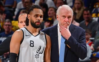 DENVER, CO - APRIL 27: Patty Mills #8, and Head Coach Gregg Popovich of the San Antonio Spurs are seen together against the Denver Nuggets during Game Seven of Round One of the 2019 NBA Playoffs on April 27, 2019 at the Pepsi Center in Denver, Colorado. NOTE TO USER: User expressly acknowledges and agrees that, by downloading and/or using this Photograph, user is consenting to the terms and conditions of the Getty Images License Agreement. Mandatory Copyright Notice: Copyright 2019 NBAE (Photo by Bart Young/NBAE via Getty Images)
