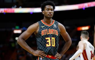 MIAMI, FLORIDA - OCTOBER 14:  Damian Jones #30 of the Atlanta Hawks looks on against the Miami Heat during the first half of the preseason game at American Airlines Arena on October 14, 2019 in Miami, Florida. NOTE TO USER: User expressly acknowledges and agrees that, by downloading and or using this photograph, User is consenting to the terms and conditions of the Getty Images License Agreement.  (Photo by Michael Reaves/Getty Images)