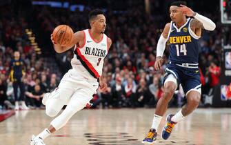 PORTLAND, OREGON - OCTOBER 23: CJ McCollum #3 of the Portland Trail Blazers dribbles alongside Gary Harris #14 of the Denver Nuggets in the first quarter during their season opener at Moda Center on October 23, 2019 in Portland, Oregon. NOTE TO USER: User expressly acknowledges and agrees that, by downloading and or using this photograph, User is consenting to the terms and conditions of the Getty Images License Agreement (Photo by Abbie Parr/Getty Images)