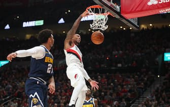 PORTLAND, OREGON - OCTOBER 23: Damian Lillard #0 of the Portland Trail Blazers dunks the ball alongside Jamal Murray #27 of the Denver Nuggets in the first quarter during their season opener at Moda Center on October 23, 2019 in Portland, Oregon. NOTE TO USER: User expressly acknowledges and agrees that, by downloading and or using this photograph, User is consenting to the terms and conditions of the Getty Images License Agreement (Photo by Abbie Parr/Getty Images)