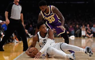 LOS ANGELES, CALIFORNIA - OCTOBER 25:  Donovan Mitchell #45 of the Utah Jazz saves a ball out of bounds in front of Troy Daniels #30 of the Los Angeles Lakers during the first half at Staples Center on October 25, 2019 in Los Angeles, California. (Photo by Harry How/Getty Images)