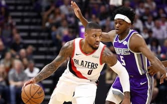 SACRAMENTO, CALIFORNIA - OCTOBER 25:   Damian Lillard #0 of the Portland Trail Blazers is guarded by De'Aaron Fox #5 of the Sacramento Kings at Golden 1 Center on October 25, 2019 in Sacramento, California.  NOTE TO USER: User expressly acknowledges and agrees that, by downloading and or using this photograph, User is consenting to the terms and conditions of the Getty Images License Agreement. (Photo by Ezra Shaw/Getty Images)