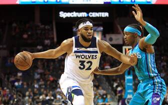 CHARLOTTE, NORTH CAROLINA - OCTOBER 25: Karl-Anthony Towns #32 of the Minnesota Timberwolves drives to the basket against Devonte' Graham #4 of the Charlotte Hornets during their game at Spectrum Center on October 25, 2019 in Charlotte, North Carolina. NOTE TO USER: User expressly acknowledges and agrees that, by downloading and or using this photograph, User is consenting to the terms and conditions of the Getty Images License Agreement. (Photo by Streeter Lecka/Getty Images)