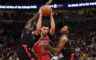 CHICAGO, ILLINOIS - OCTOBER 26:  Zach LaVine #8 of the Chicago Bulls drives between Pascal Siakam #43 and Kyle Lowry #7 of the Toronto Raptors during the second half of a game at United Center on October 26, 2019 in Chicago, Illinois.  NOTE TO USER: User expressly acknowledges and agrees that, by downloading and or using this photograph, User is consenting to the terms and conditions of the Getty Images License Agreement. (Photo by Stacy Revere/Getty Images)