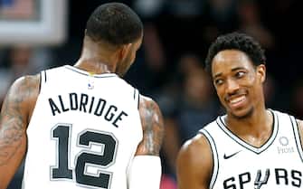 SAN ANTONIO, TX - FEBRUARY  27:  DeMar DeRozan #10 of the San Antonio Spurs is all smiles with LaMarcus Aldridge #12 of the San Antonio Spurs after defeating the Detroit Pistons at AT&T Center on February 27, 2019 in San Antonio, Texas.  NOTE TO USER: User expressly acknowledges and agrees that , by downloading and or using this photograph, User is consenting to the terms and conditions of the Getty Images License Agreement. (Photo by Ronald Cortes/Getty Images)