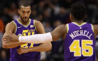 PHOENIX, ARIZONA - MARCH 13:  Rudy Gobert #27 of the Utah Jazz is congratulated by Donovan Mitchell #45 after scoring against the Phoenix Suns during the first half of the NBA game at Talking Stick Resort Arena on March 13, 2019 in Phoenix, Arizona. (Photo by Christian Petersen/Getty Images)