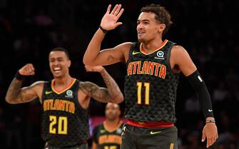 NEW YORK, NEW YORK - OCTOBER 16: Trae Young #11 and John Collins #20 of the Atlanta Hawks react during the second quarter of the preseason game against the New York Knicks at Madison Square Garden on October 16, 2019 in New York City. NOTE TO USER: User expressly acknowledges and agrees that, by downloading and or using this Photograph, user is consenting to the terms and conditions of the Getty Images License Agreement. Mandatory Copyright Notice: Copyright 2019 NBAE (Photo by Sarah Stier/Getty Images)
