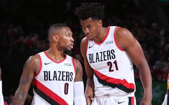 PORTLAND, OR - OCTOBER 23: Damian Lillard #0 and Hassan Whiteside #21 of the Portland Trail Blazers talk during a game against the Denver Nuggets on October 23, 2019 at the Moda Center Arena in Portland, Oregon. NOTE TO USER: User expressly acknowledges and agrees that, by downloading and or using this photograph, user is consenting to the terms and conditions of the Getty Images License Agreement. Mandatory Copyright Notice: Copyright 2019 NBAE (Photo by Sam Forencich/NBAE via Getty Images)