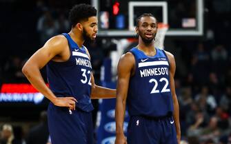 MINNEAPOLIS, MN - JANUARY 20: Karl-Anthony Towns #32 and Andrew Wiggins #22 of the Minnesota Timberwolves talk during a timeout in the third quarter during the game against the Phoenix Suns at Target Center on January 20, 2019 in Minneapolis, Minnesota. The Minnesota Timberwolves defeated the Phoenix Suns 116-114. NOTE TO USER: User expressly acknowledges and agrees that, by downloading and or using this Photograph, user is consenting to the terms and conditions of the Getty Images License Agreement. (Photo by David Berding/Getty Images)