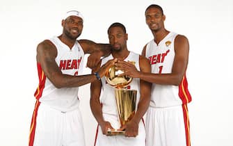 MIAMI, FL - SEPTEMBER 28:  (L-R) LeBron James #6, Dwyane Wade #3 and Chris Bosh #1 of the Miami Heat pose for a portrait with the Larry O'Brien trophy during the 2012 Miami Heat Media Day on September 28, 2012 at American Airlines Arena in Miami, Florida. NOTE TO USER: User expressly acknowledges and agrees that, by downloading and/or using this Photograph, User is consenting to the terms and conditions of the Getty Images License Agreement. Mandatory copyright notice: Copyright NBAE 2012 (Photo by Issac Baldizon/NBAE via Getty Images)
