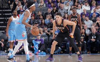 SACRAMENTO, CA - FEBRUARY 10: Devin Booker #1 of the Phoenix Suns defends De'Aaron Fox #5 of the Sacramento Kings on February 10, 2019 at Golden 1 Center in Sacramento, California. NOTE TO USER: User expressly acknowledges and agrees that, by downloading and or using this photograph, User is consenting to the terms and conditions of the Getty Images Agreement. Mandatory Copyright Notice: Copyright 2019 NBAE (Photo by Rocky Widner/NBAE via Getty Images)