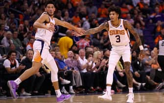 PHOENIX, ARIZONA - OCTOBER 23: Kelly Oubre Jr. #3 of the Phoenix Suns high fives Devin Booker #1 after scoring against the Sacramento Kings during the second half of the NBA game at Talking Stick Resort Arena on October 23, 2019 in Phoenix, Arizona. The Suns defeated the Kings 124-95. NOTE TO USER: User expressly acknowledges and agrees that, by downloading and/or using this photograph, user is consenting to the terms and conditions of the Getty Images License Agreement (Photo by Christian Petersen/Getty Images)