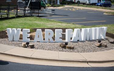 AKRON, OH - JULY 30: A large "WE ARE FAMILY" bench is seen at the grand opening of the I Promise school on July 30, 2018 in Akron, Ohio. The new school is a partnership between the LeBron James Family foundation and Akron Public Schools. NOTE TO USER: User expressly acknowledges and agrees that, by downloading and/or using this Photograph, user is consenting to the terms and conditions of the Getty Images License Agreement. Mandatory Copyright Notice: Copyright 2018 NBAE (Photo by Allison Farrand/NBAE via Getty Images)