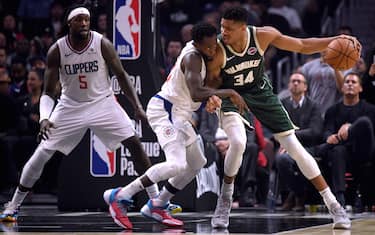 LOS ANGELES, CALIFORNIA - NOVEMBER 06:  Giannis Antetokounmpo #34 of the Milwaukee Bucks back down Patrick Beverley #21 of the LA Clippers as Montrezl Harrell #5 looks on during the first half at Staples Center on November 06, 2019 in Los Angeles, California. (Photo by Harry How/Getty Images)  NOTE TO USER: User expressly acknowledges and agrees that, by downloading and or using this photograph, User is consenting to the terms and conditions of the Getty Images License Agreement.