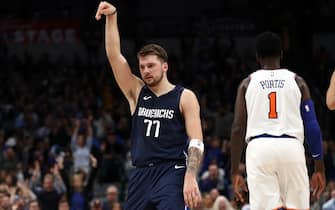DALLAS, TEXAS - NOVEMBER 08:  Luka Doncic #77 of the Dallas Mavericks celebrates a three-point shot against Bobby Portis #1 of the New York Knicks in the second half at American Airlines Center on November 08, 2019 in Dallas, Texas.  NOTE TO USER: User expressly acknowledges and agrees that, by downloading and or using this photograph, User is consenting to the terms and conditions of the Getty Images License Agreement. (Photo by Ronald Martinez/Getty Images)